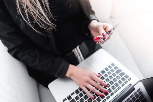 woman on laptop and phone